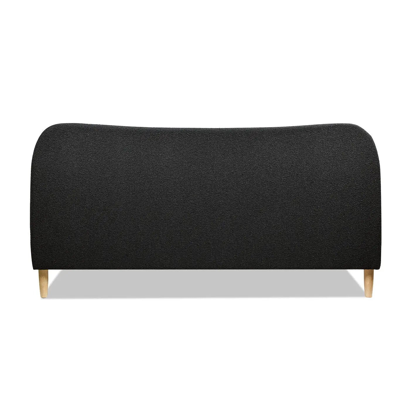 Roman curved headboard upholstered platform bed in black fabric with light wood legs on Tampa Home & Garden Store