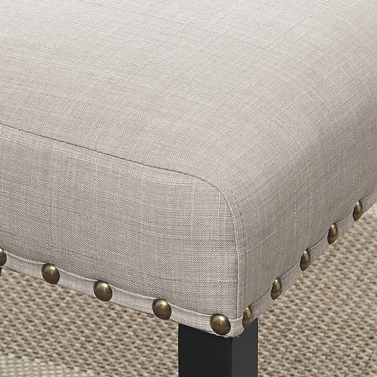 Dining chair in tan linen with brass nailhead trim and espresso wood leg on Tampa Home & Garden Store