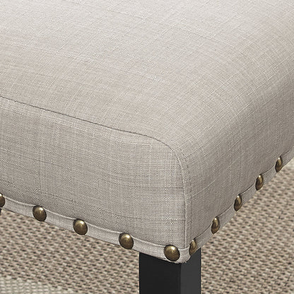 Dining chair in tan linen with brass nailhead trim and espresso wood leg on Tampa Home & Garden Store