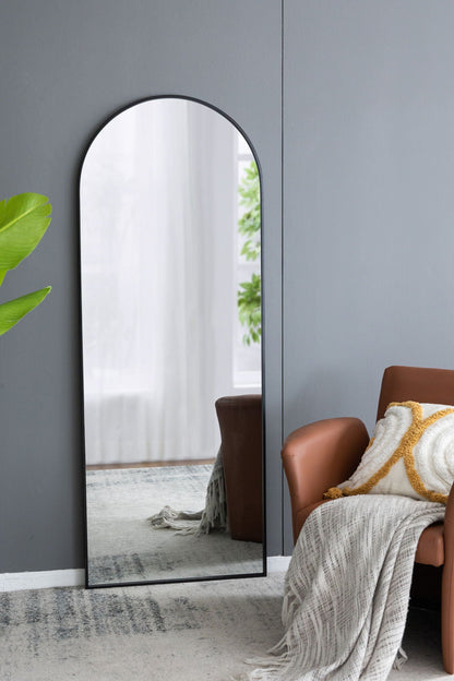 The Celine Arch Body Mirror by HouseOfZazla, slim black arched mirror leaning against wall on Tampa Home & Garden Store