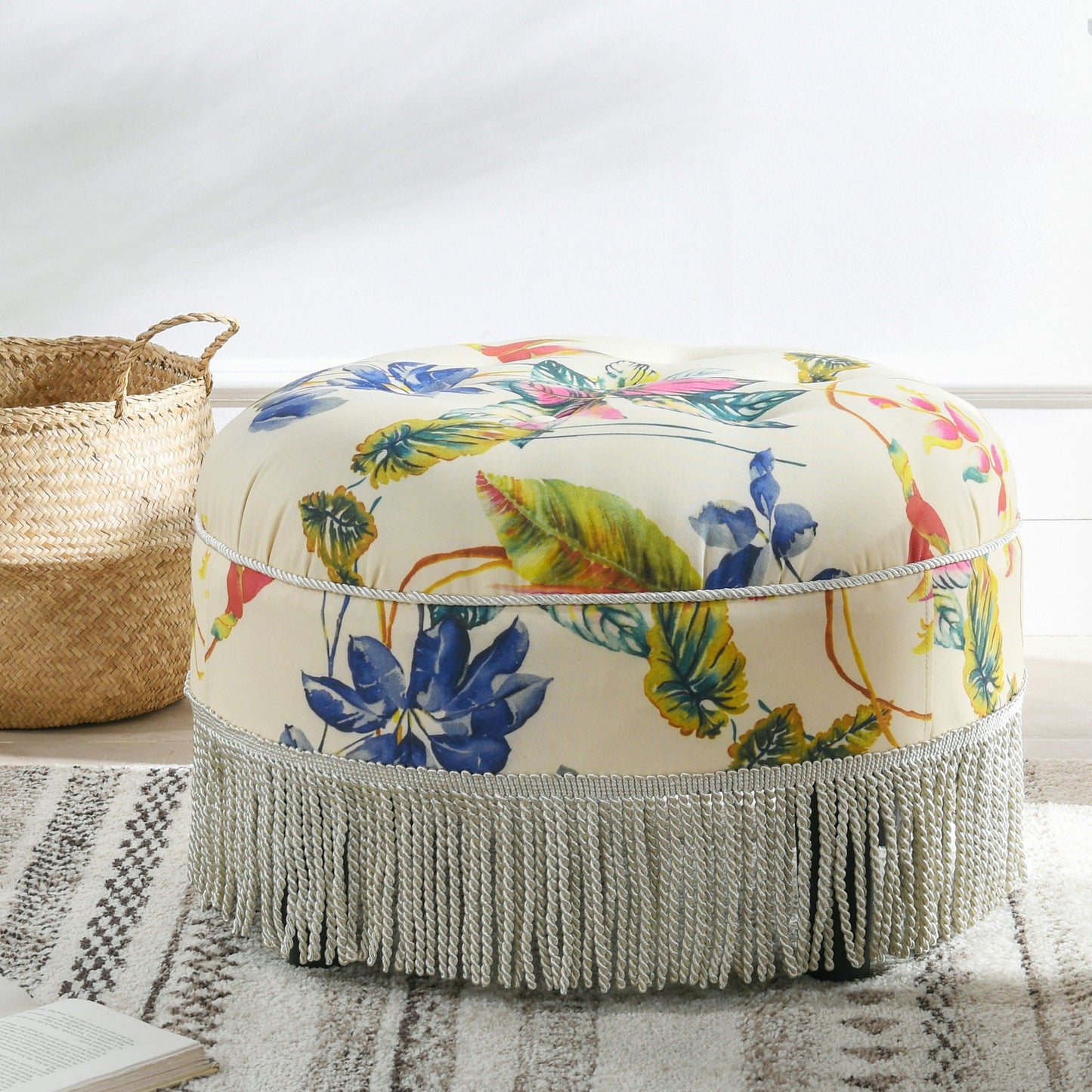 Yolanda round upholstered ottoman in cream fabric with floral print and rope fringe on Tampa Home & Garden Store
