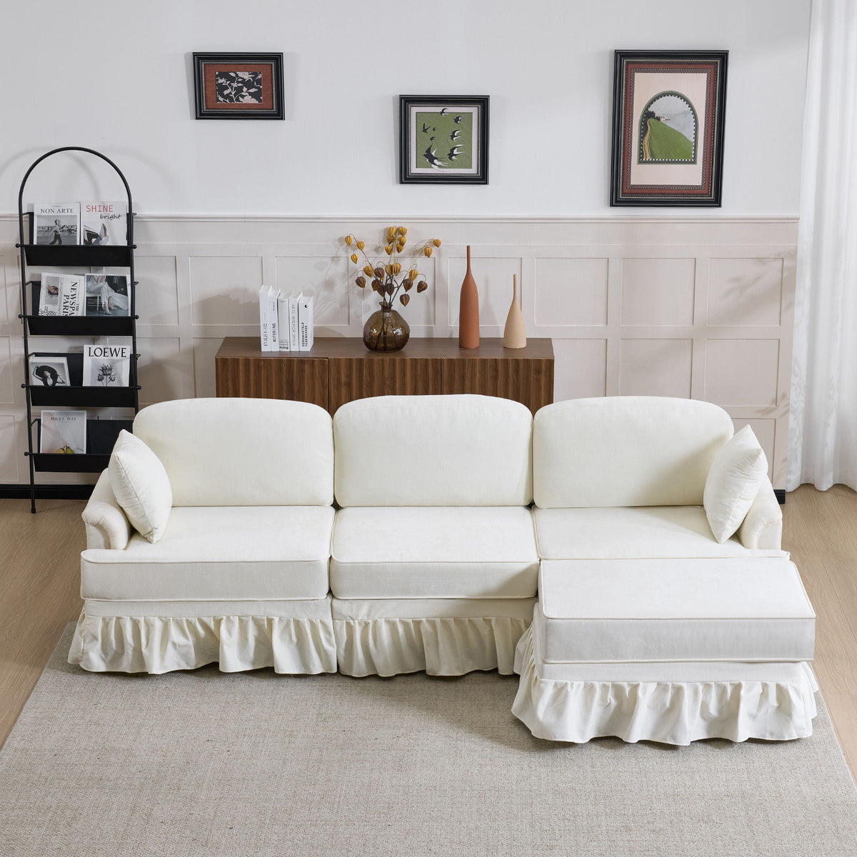 White L-shaped sectional sofa with removable ruffled skirt and ottoman in a modern living room on Tampa Home & Garden Store