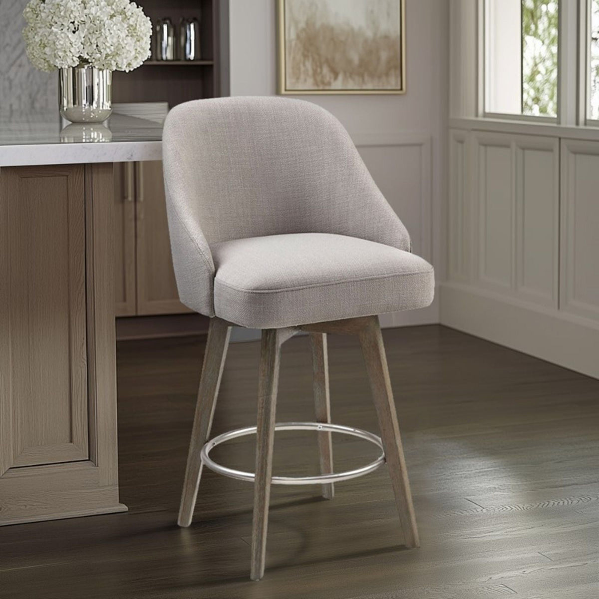 Counter height swivel stool in beige fabric with solid wood legs and metal footrest at island on Tampa Home & Garden Store