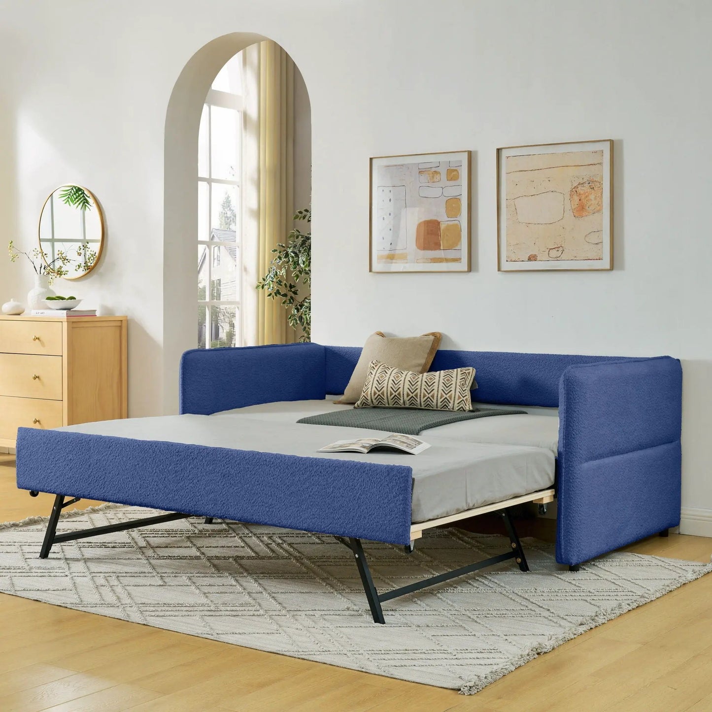 Upholstered daybed with pop-up trundle in blue fabric, two-bed setup on black metal legs on Tampa Home & Garden Store