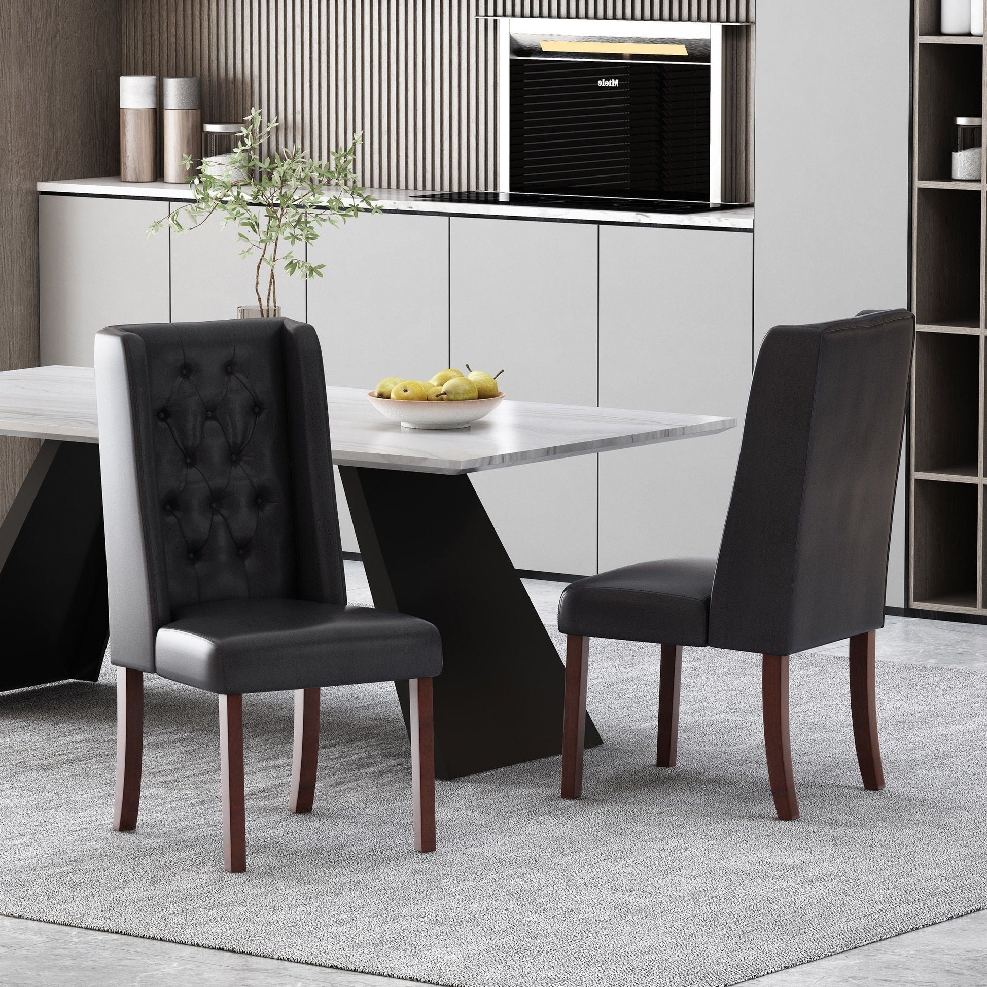 Four tufted dining chairs with high backs in black leather around a marble table on Tampa Home & Garden Store