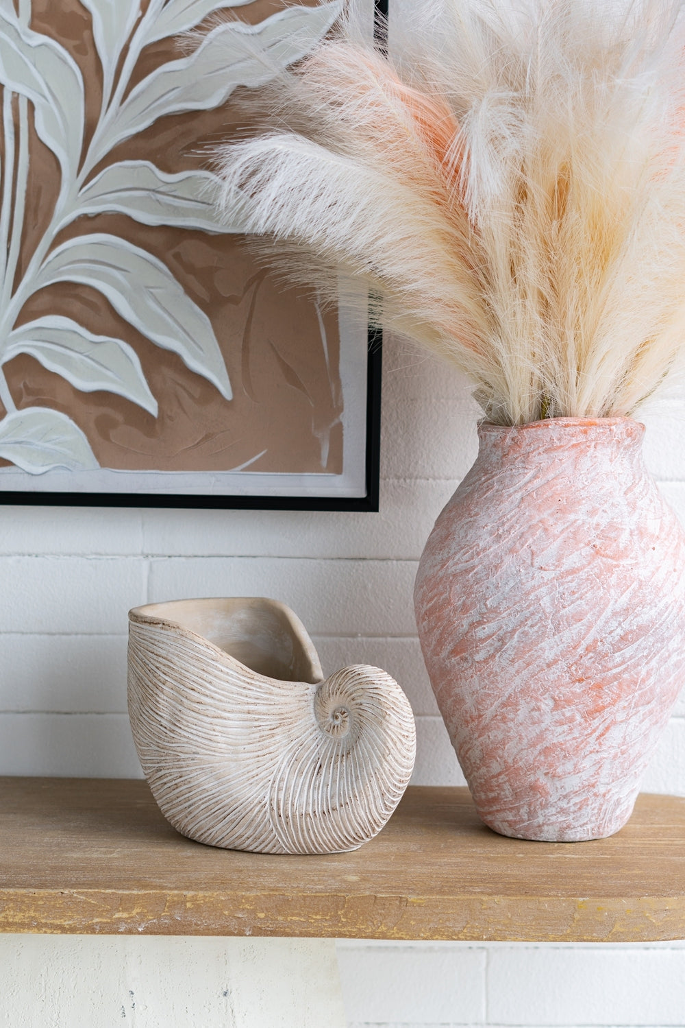 Nautilus shell planter and pampas grass vase in beige sand-cement finish, two decor pieces on Tampa Home & Garden Store