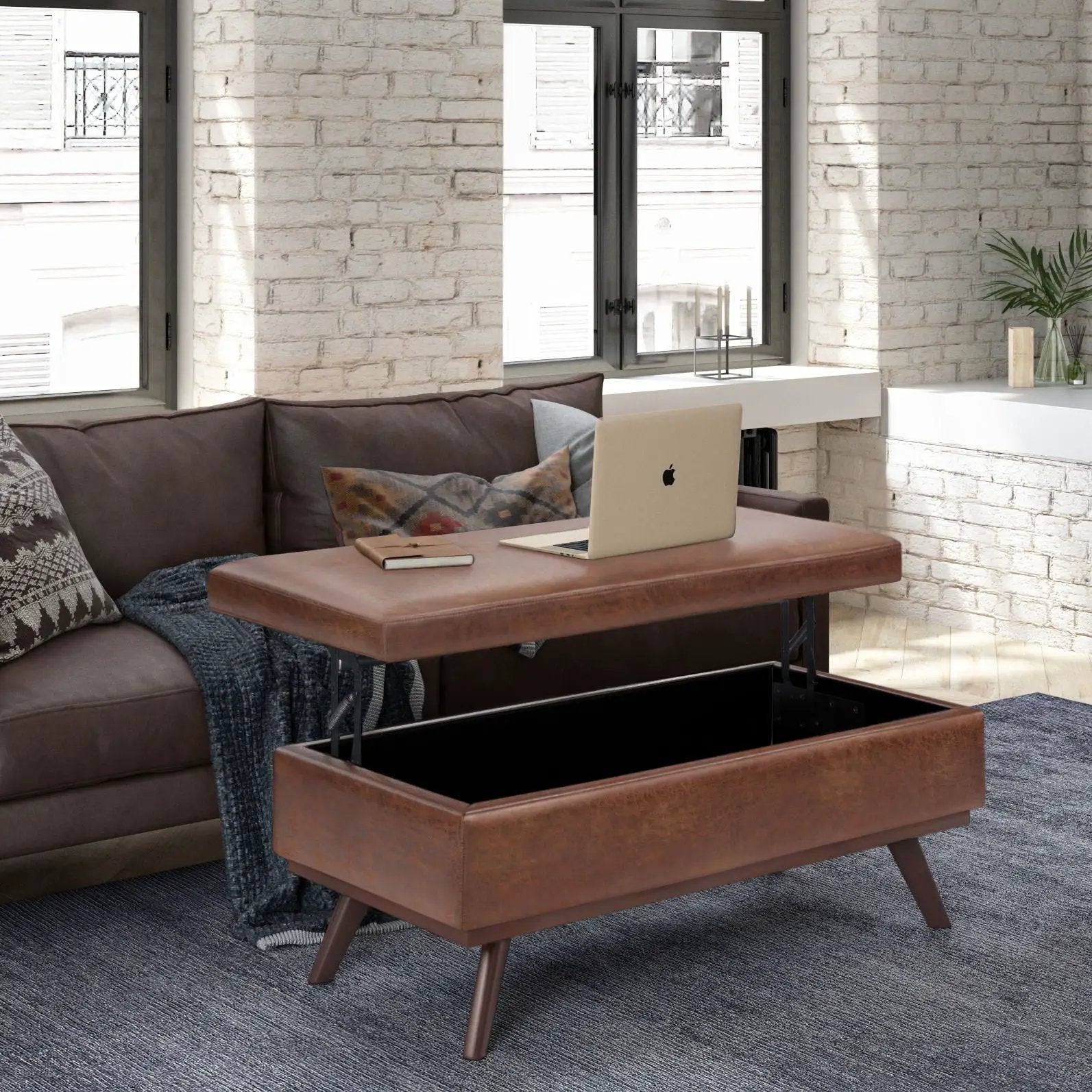 Owen lift-top brown leather storage ottoman with mid-century legs open storage in living room on Tampa Home & Garden Store