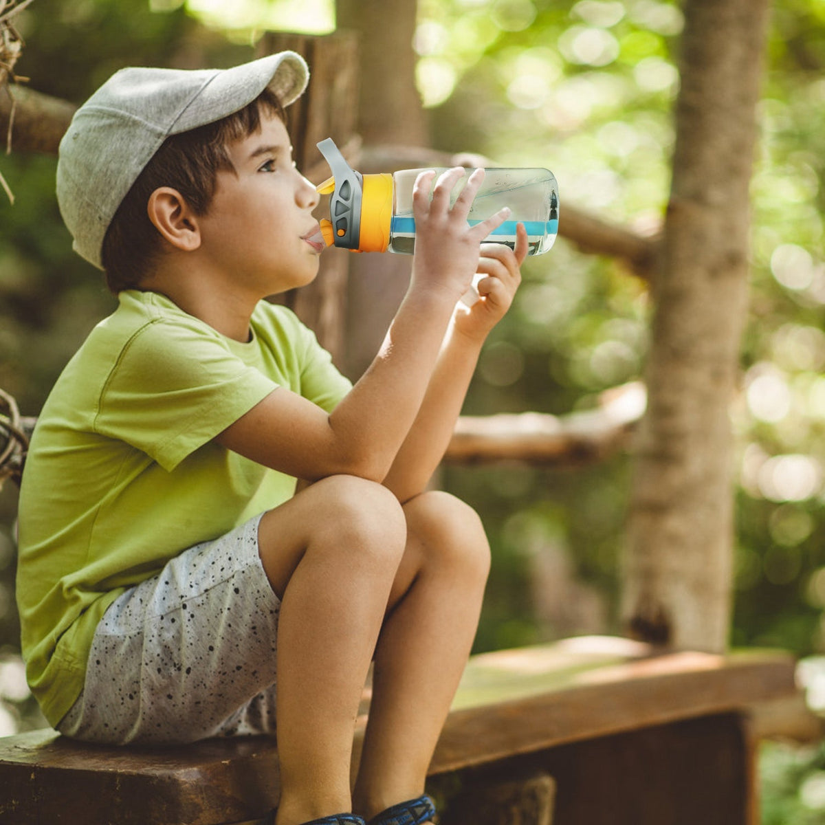 Leakproof kids water bottle with straw, orange lid held by a kid on Tampa Home & Garden Store