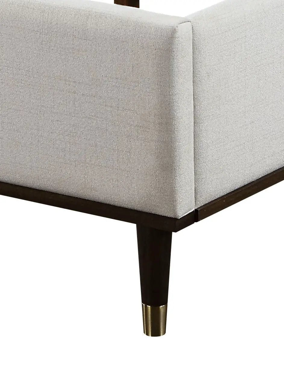 Carena Comfort Bed upholstered bed in light gray fabric with dark wood legs and brass foot caps on Tampa Home & Garden Store
