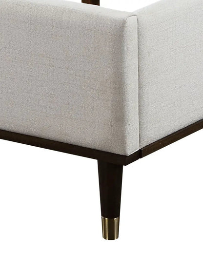 Carena Comfort Bed upholstered bed in light gray fabric with dark wood legs and brass foot caps on Tampa Home & Garden Store