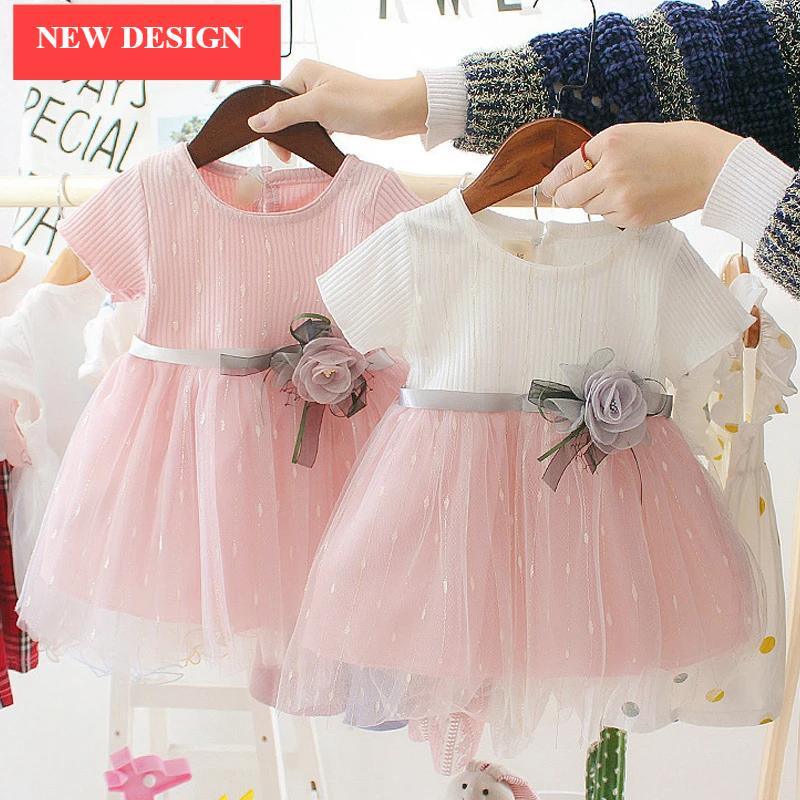Luxury newborn girl dress set in pink and white tulle with satin bow, two dresses on hangers on Tampa Home & Garden Store