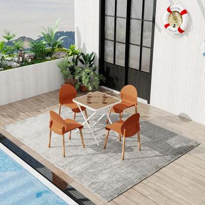 Outdoor dining set: 4 orange chairs with a white folding square table on a wooden deck by pool on Tampa Home & Garden Store