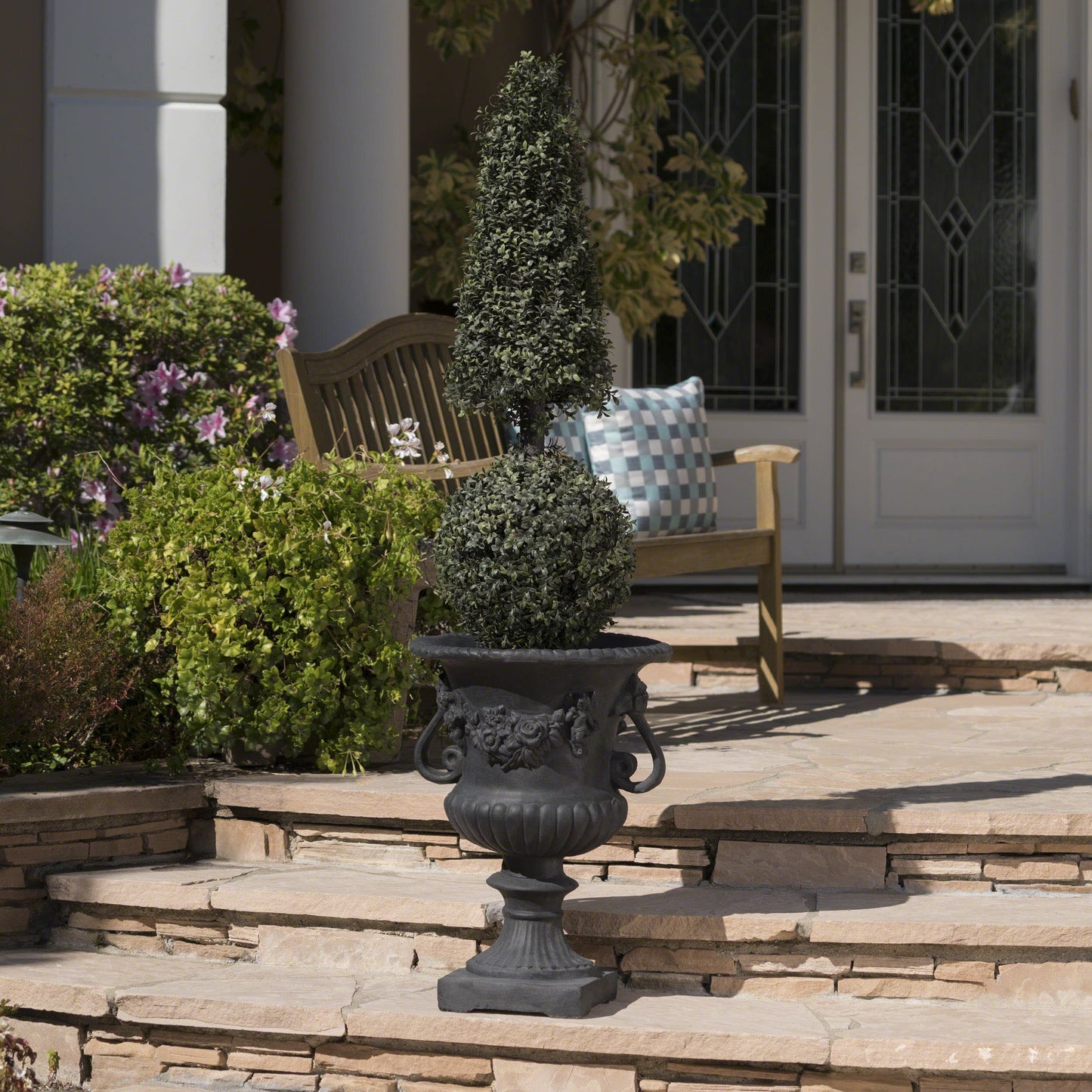 Buena Vista Urn planter in black cast iron with a tall cone-shaped topiary on Tampa Home & Garden Store