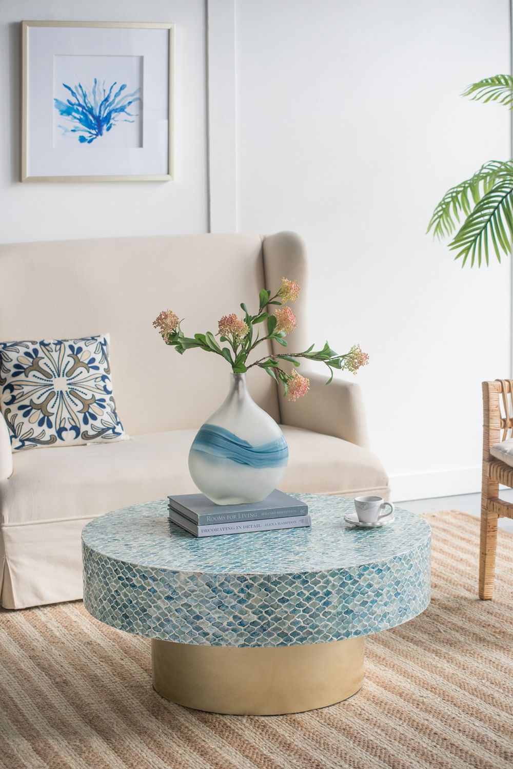 Capiz coffee table with pedestal base; round blue mosaic tile top in a neutral living room on Tampa Home & Garden Store