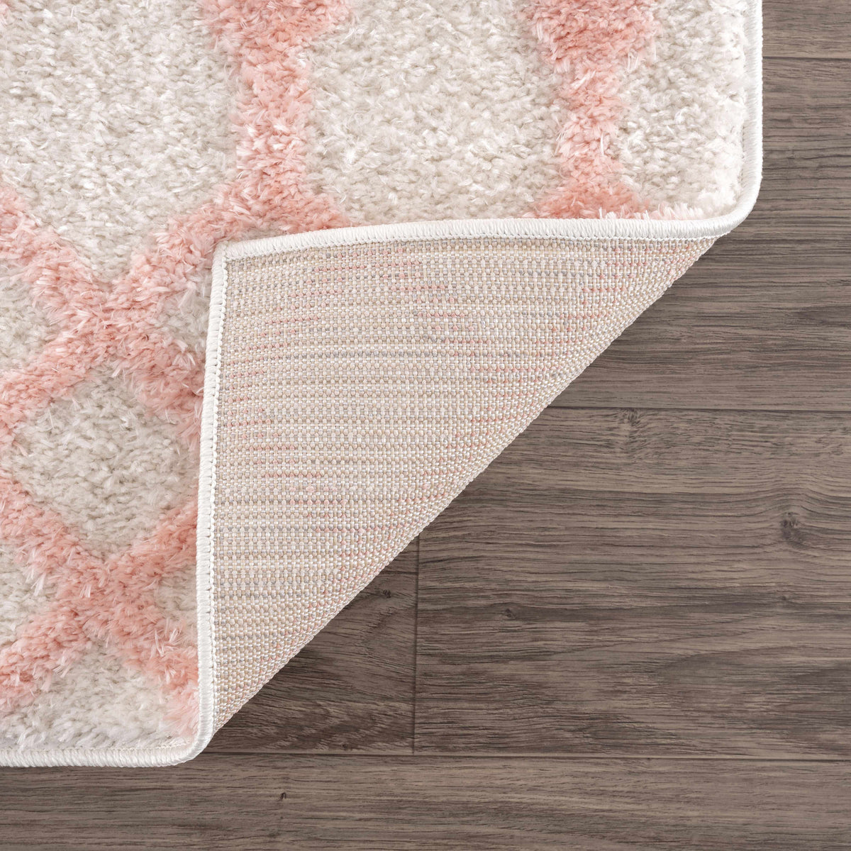Darva Pink Plush Area Rug with ivory base and pink stripes; soft shag texture on wood floor on Tampa Home & Garden Store