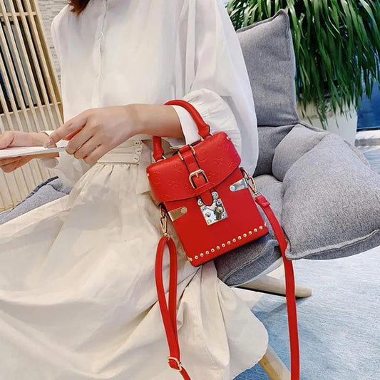 Crossbody bag red leather with buckle and metal studs, compact designer handbag on Tampa Home & Garden Store