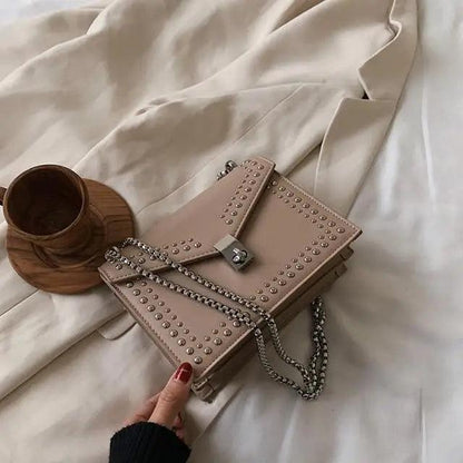 Dazzling scrub leather shoulder bag with studded edges and silver chain crossbody strap on Tampa Home & Garden Store