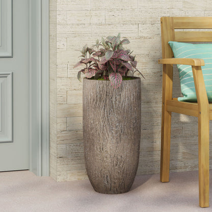 Magnesium oxide planter in natural wood finish with pink foliage on a patio beside a chair on Tampa Home & Garden Store