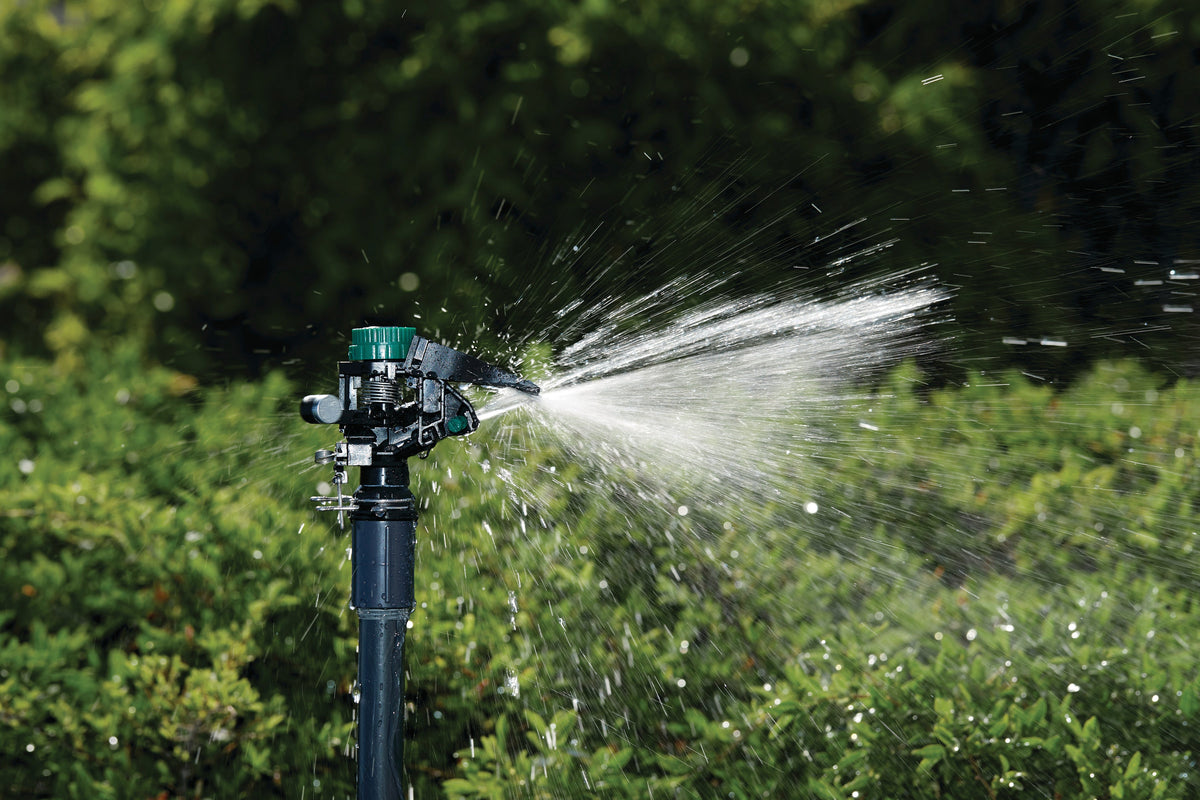 1/2 in MPT impact sprinkler head with weighted arm Orbit Irrigation spraying water outdoors on Tampa Home & Garden Store