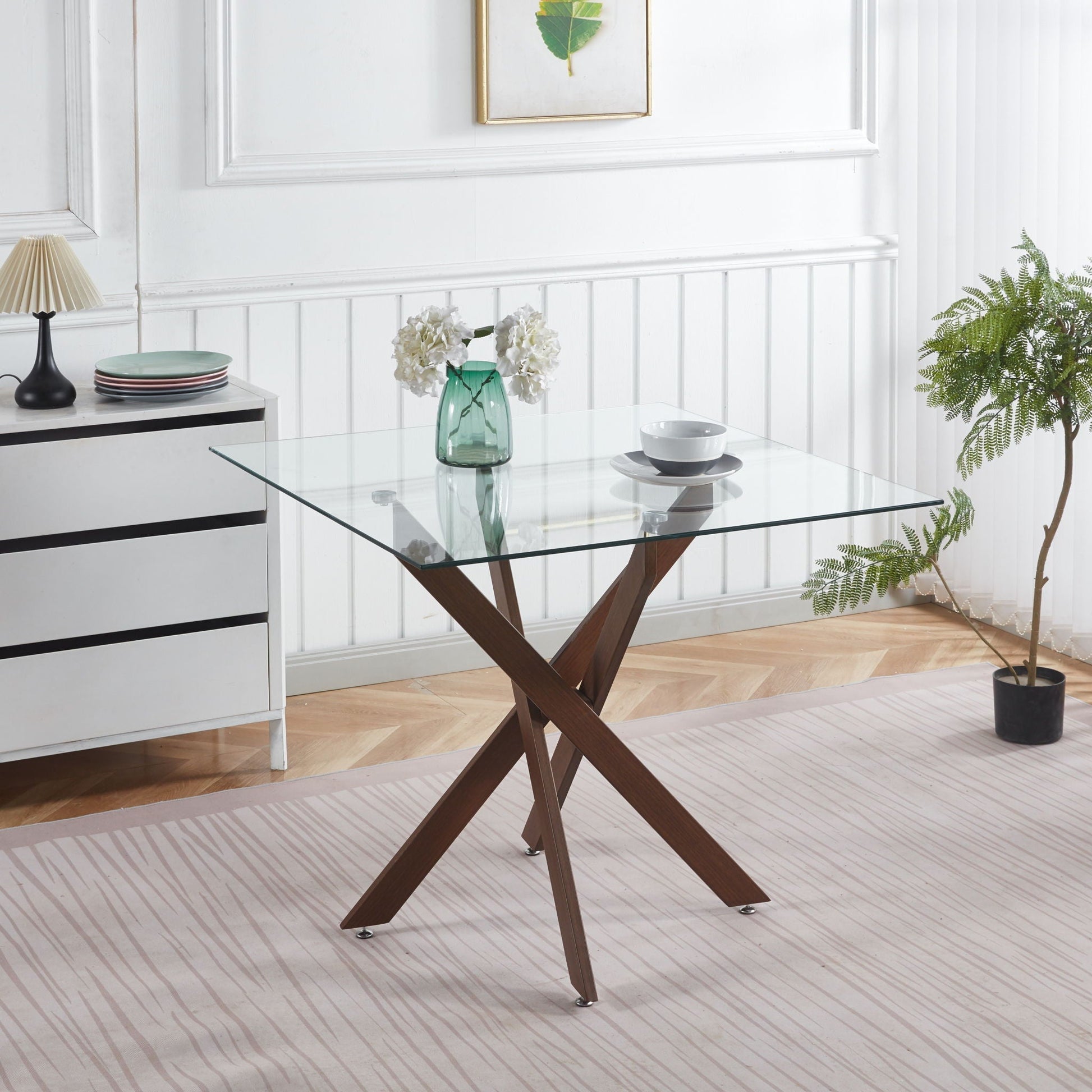 Dining table with tempered glass top and X-shaped wooden legs, modern space-saving kitchen table on Tampa Home & Garden Store