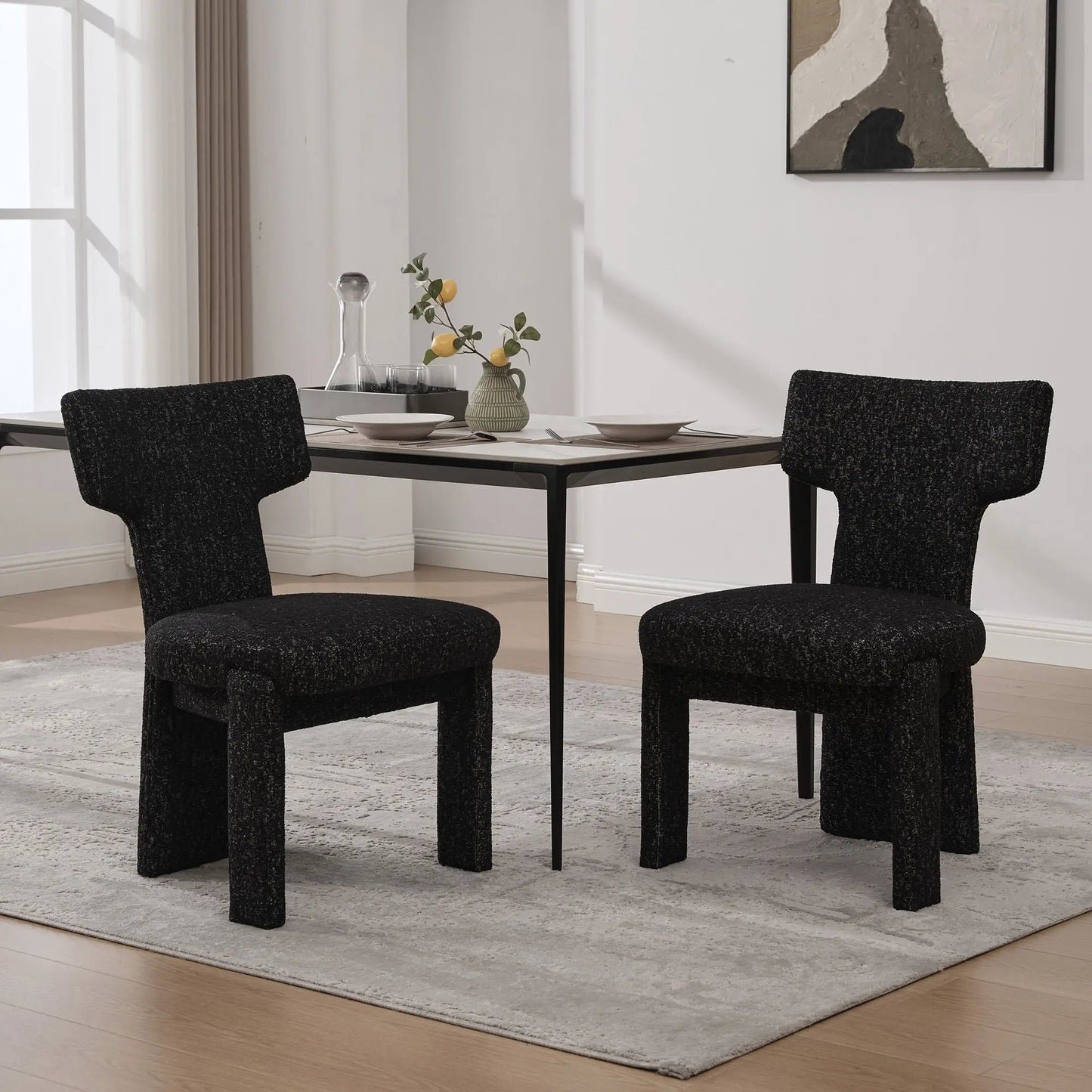 Armless curved-back accent chairs in dark textured fabric around a modern dining table on Tampa Home & Garden Store