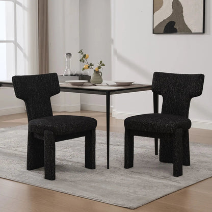 Armless curved-back accent chairs in dark textured fabric around a modern dining table on Tampa Home & Garden Store
