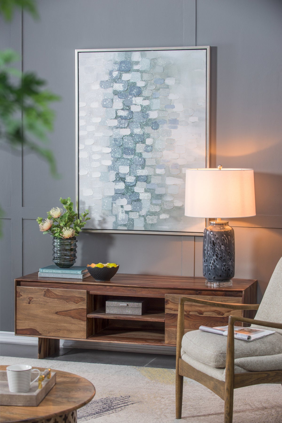 Ellis Glass Table Lamp with tall dark ceramic base and white shade on a wood console on Tampa Home & Garden Store