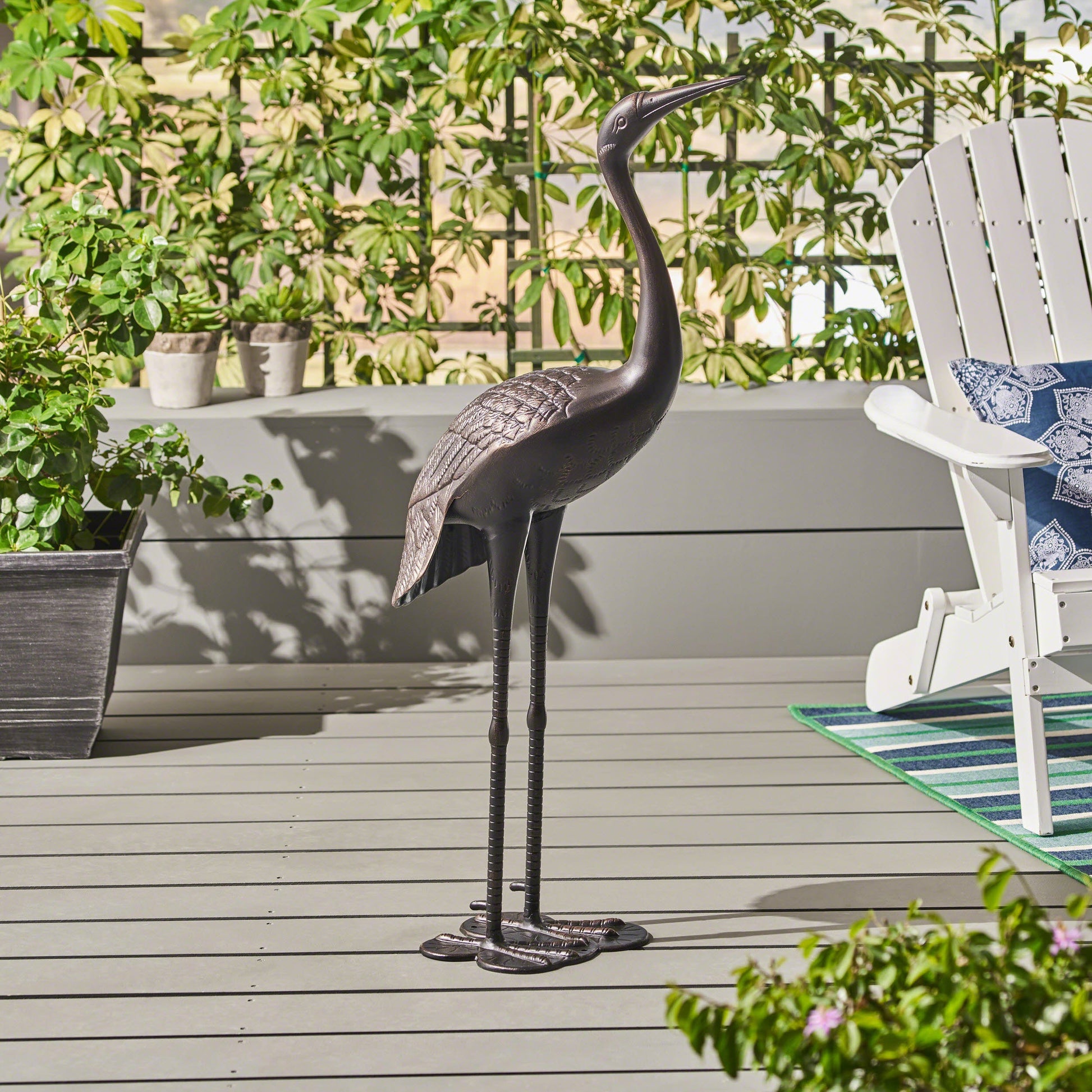 Sunny Outdoor 43 Inch Aluminum Crane statue with shiny black finish on a patio deck on Tampa Home & Garden Store