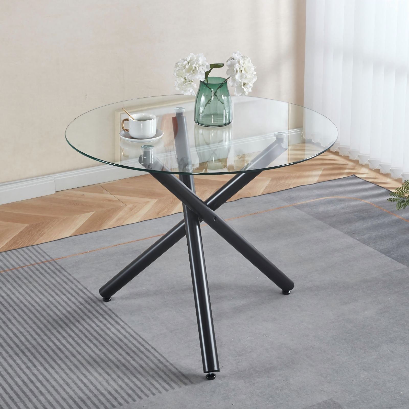 Dining Table by HouseOfZazla, round glass top with black metal cross legs on Tampa Home & Garden Store