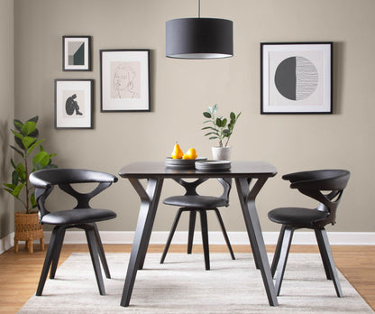 Mid-Century Modern swivel dining chair in black around a dark table in a contemporary dining room on Tampa Home & Garden Store
