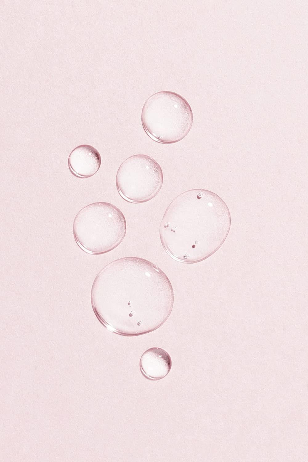Lumene vegan collagen essence serum droplets on pink background on Tampa Home & Garden Store
