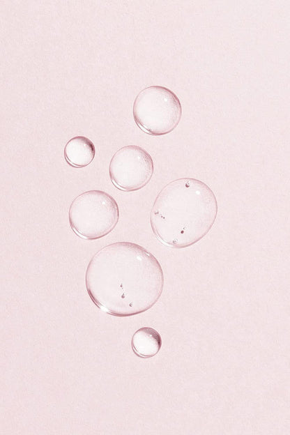 Lumene vegan collagen essence serum droplets on pink background on Tampa Home & Garden Store