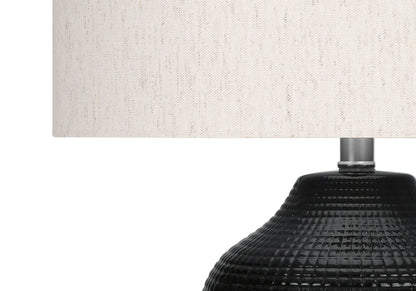 Table lamp with cream fabric shade and black textured ceramic base on Tampa Home & Garden Store