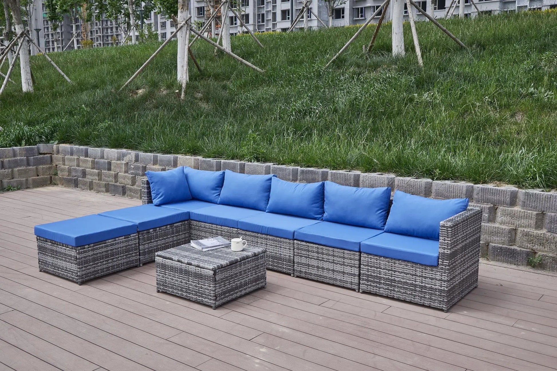 Patio sofa with blue cushions in a wicker 2-piece outdoor set by Unique Piece Furniture on Tampa Home & Garden Store