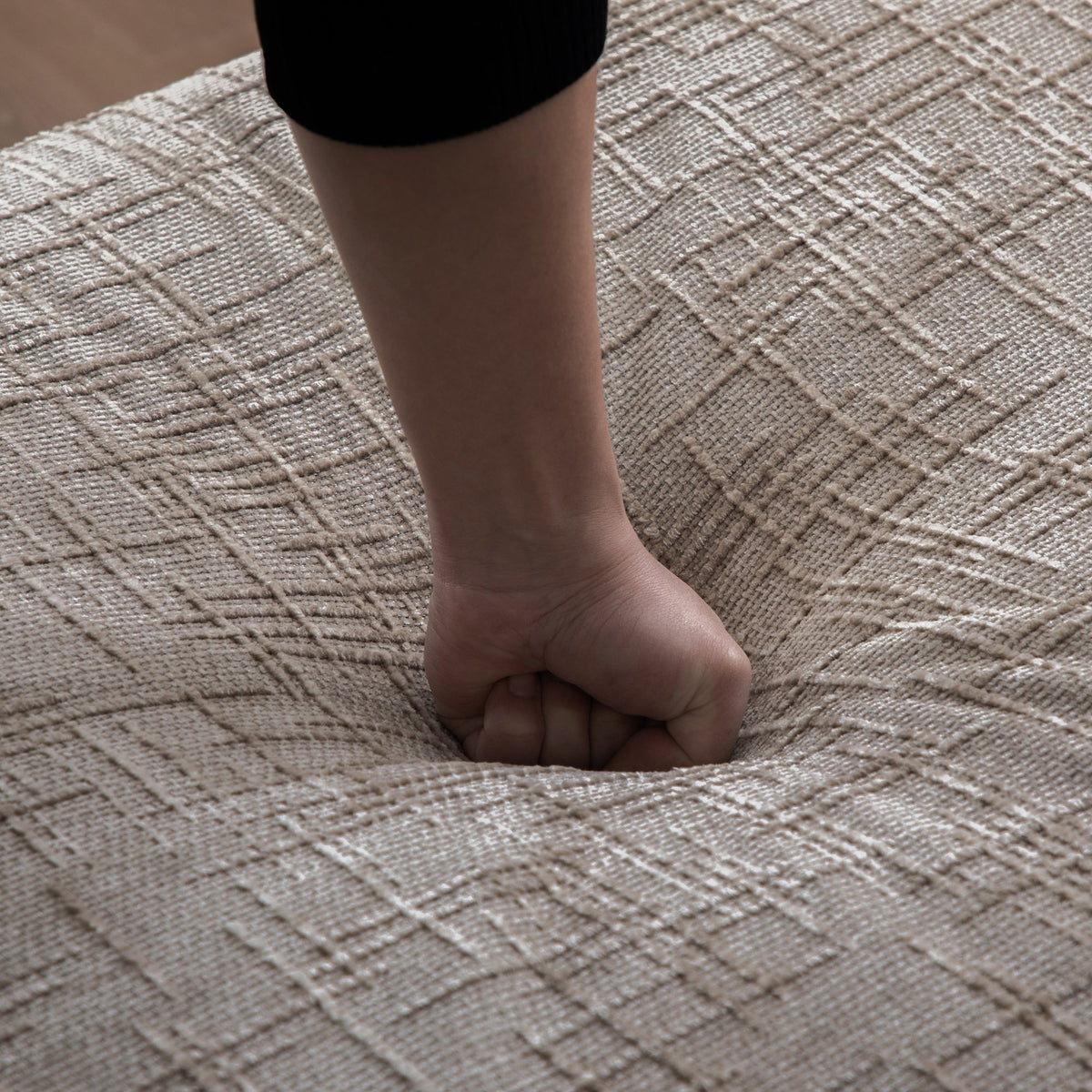 Bare leg and foot on a textured beige carpet with a black garment edge visible on Tampa Home & Garden Store