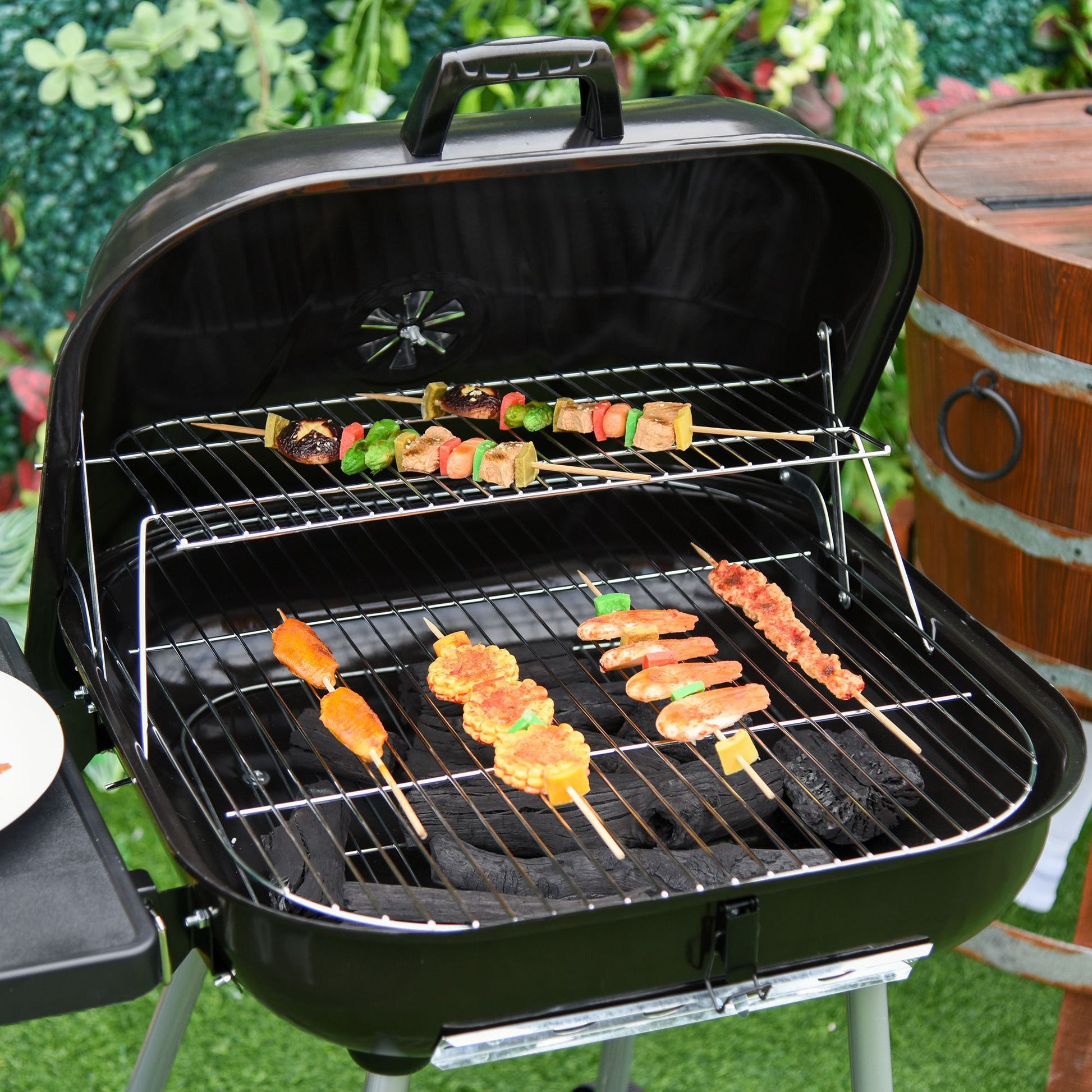 Outsunny 21' Portable Charcoal Grill with wheels and bottom shelf grilling colorful skewers on Tampa Home & Garden Store