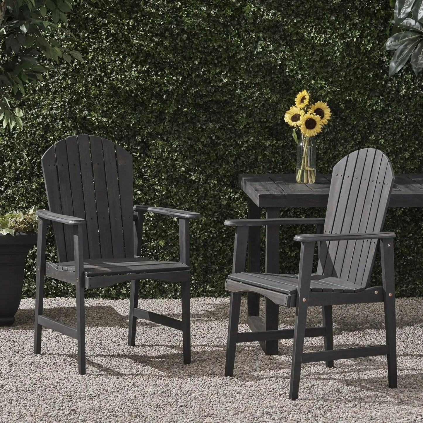 Dark gray acacia wood Adirondack dining chairs (set of 2) beside a table with sunflowers on Tampa Home & Garden Store