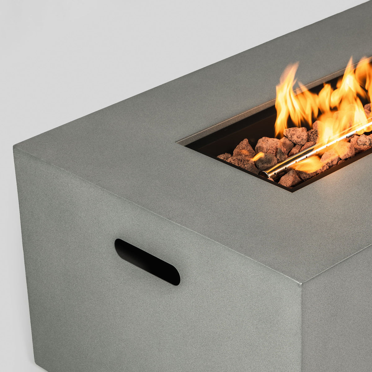 Propane gas fire pit table gray with lava rocks and visible flames in the burner area on Tampa Home & Garden Store
