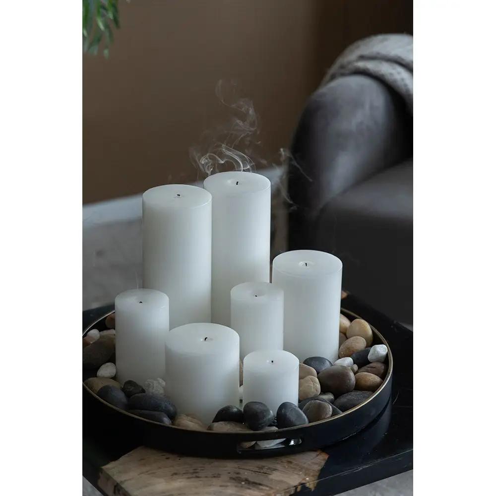 Six white unscented soy wax candles in a circular tray filled with smooth stones on Tampa Home & Garden Store