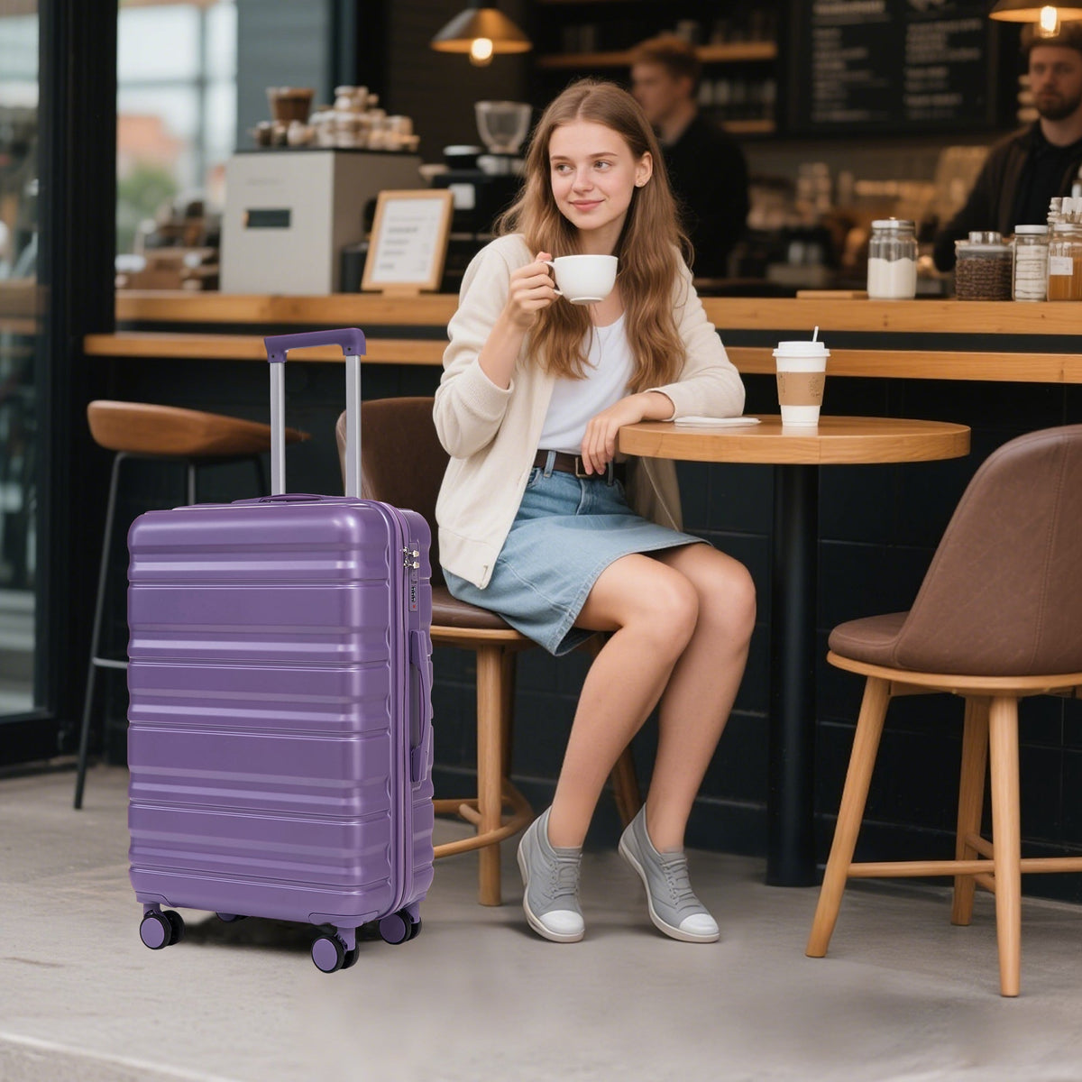 HIFINE Tourist 3-Piece ABS Spinner Luggage Set purple at cafe table beside a seated woman on Tampa Home & Garden Store
