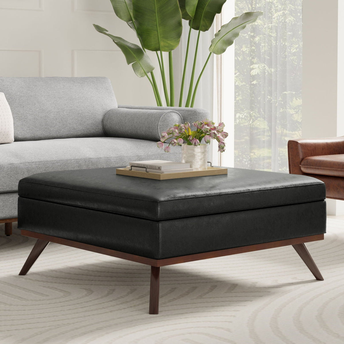 Square Lift Top Coffee Table and Storage Ottoman in black faux leather with wood legs on Tampa Home & Garden Store