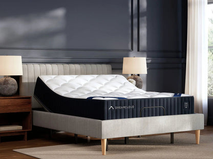 DreamCloud Classic Hybrid mattress on gray upholstered bed with tufted headboard in a dark room on Tampa Home & Garden Store