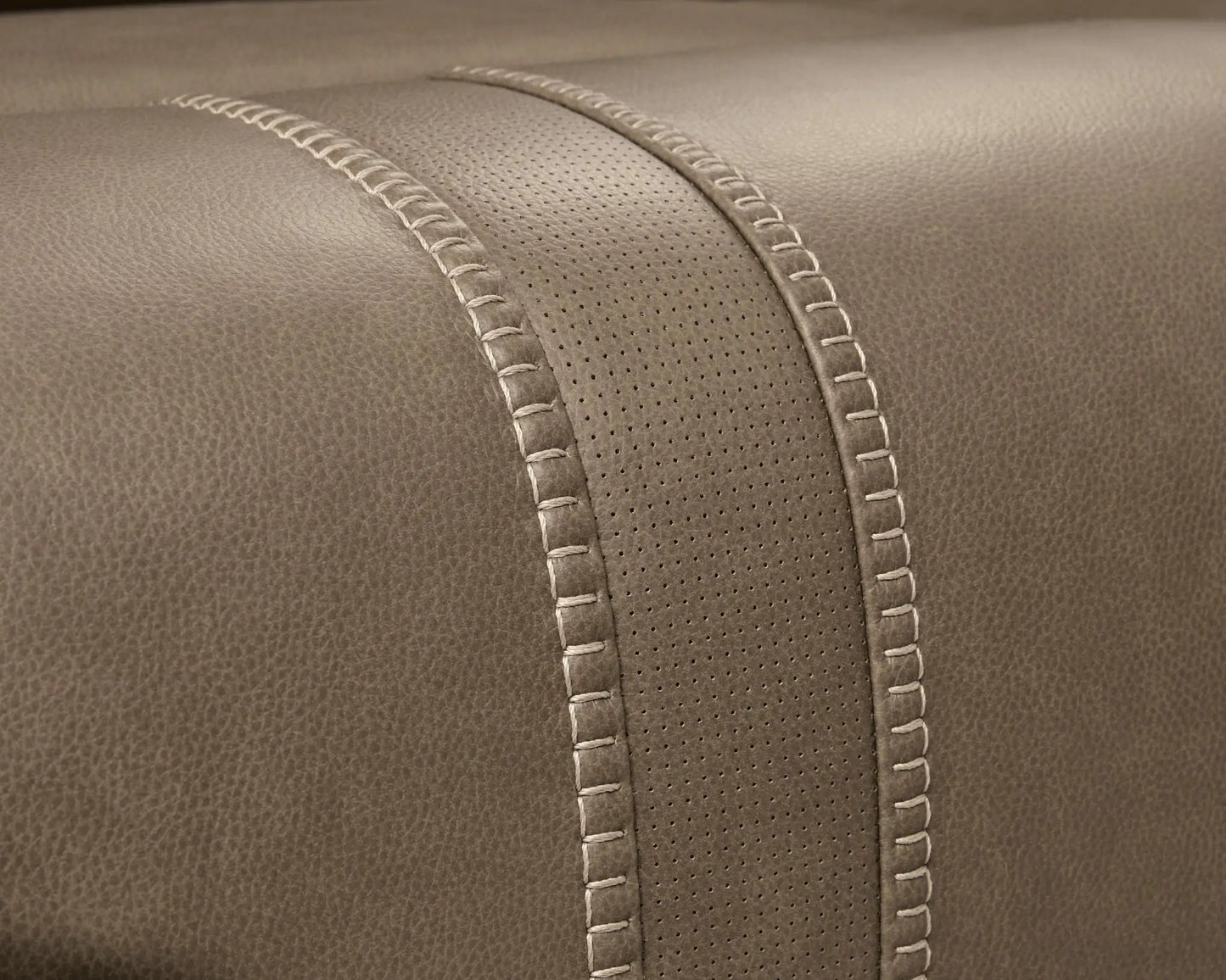 Max-Momentum reclining sectional close-up in taupe leather with perforated panel and stitching on Tampa Home & Garden Store