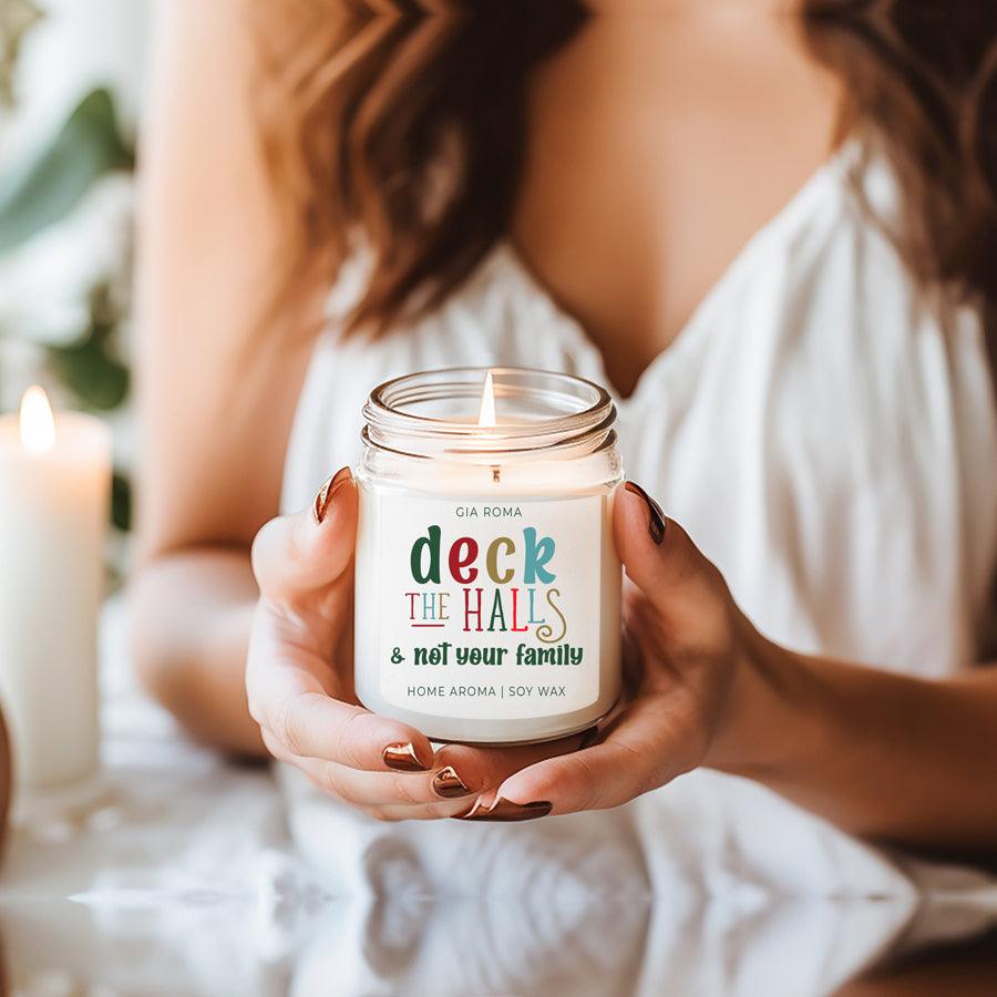 Deck The Halls Candle by Gia Roma in a clear glass jar with white label and multicolor text on Tampa Home & Garden Store