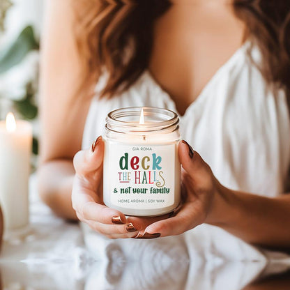 Deck The Halls Candle by Gia Roma in a clear glass jar with white label and multicolor text on Tampa Home & Garden Store
