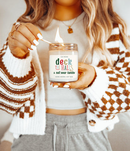 Deck The Halls Candle Gia Roma in a clear glass jar with warm flame and festive label on Tampa Home & Garden Store