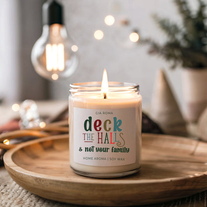 Candle Deck The Halls by Gia Roma in glass jar with label, soy wax, lit on a wooden tray on Tampa Home & Garden Store