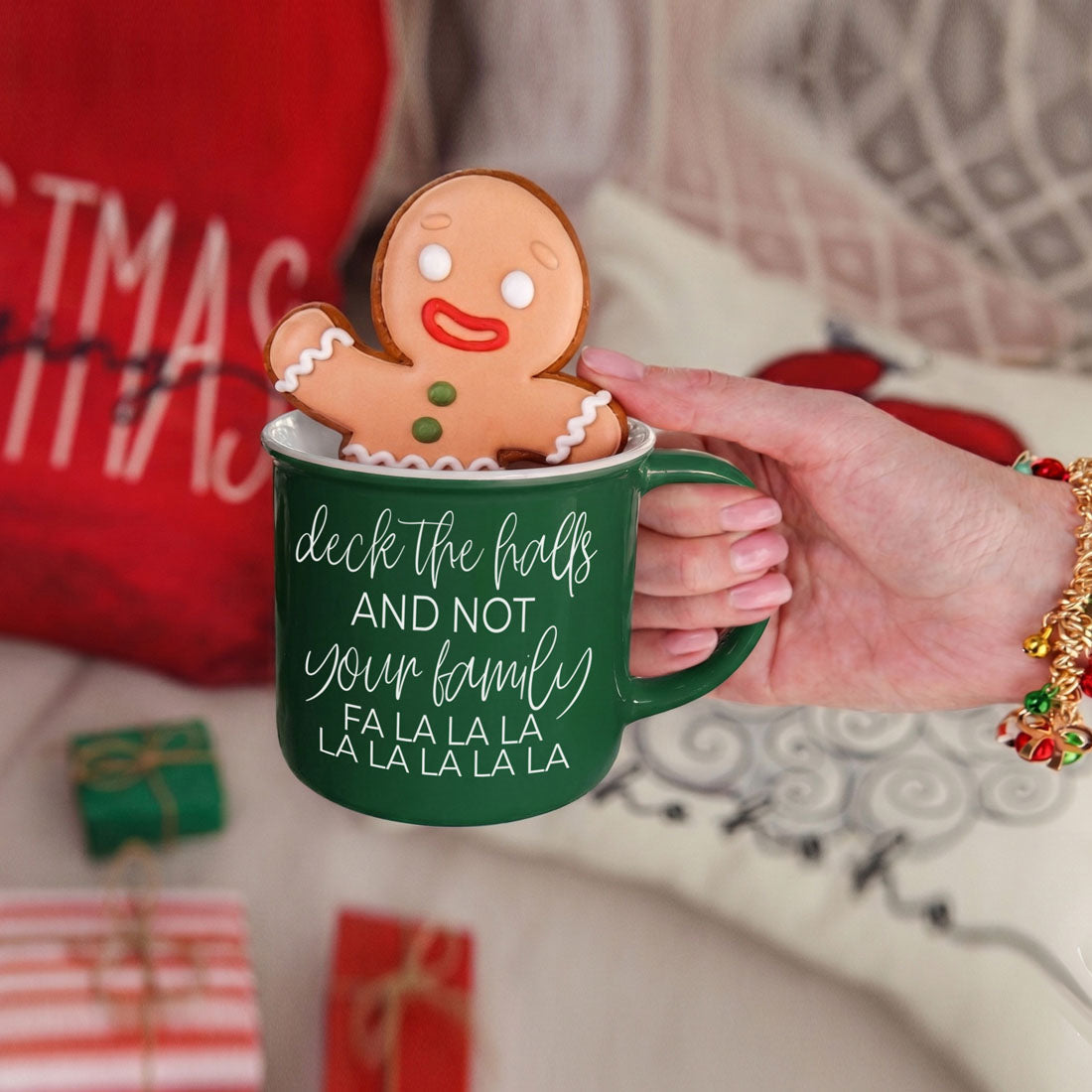 Deck The Halls mug by Gia Roma in green with a gingerbread man cookie perched on the rim on Tampa Home & Garden Store