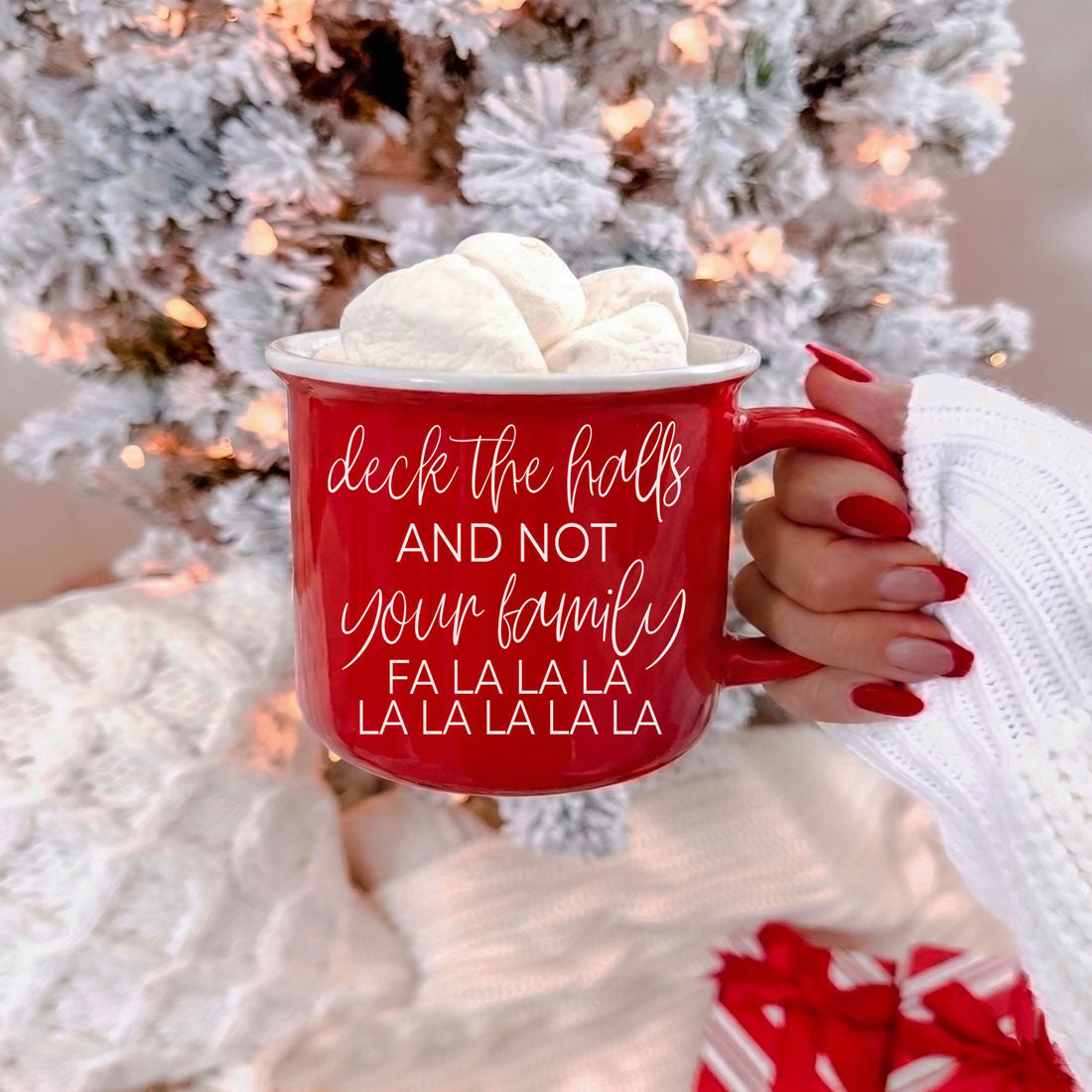 Red ceramic coffee mug with white script deck the halls and marshmallows on top on Tampa Home & Garden Store