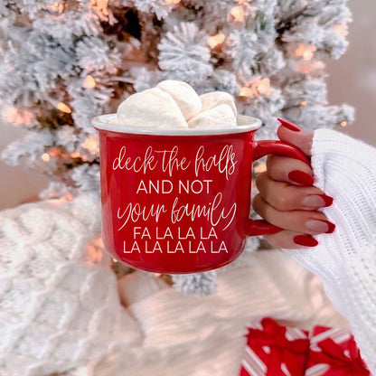 Red ceramic coffee mug with white script deck the halls and marshmallows on top on Tampa Home & Garden Store